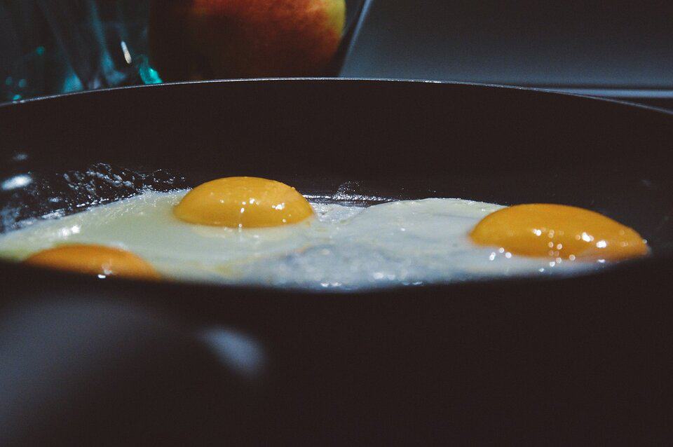 three frying eggs